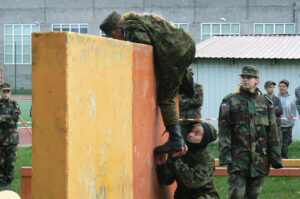 Hiiumaa noored takistust ületamas, sõpra aitab Sten Egert Tammeveski.