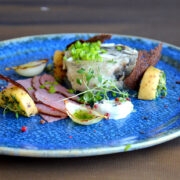 “Kui lauda jõuab kohalikul keraamikal kohalik vapikala lest, mida on koheldud lugupidavalt kergelt hapukas tarrendis, koos tummises suitsus väärindatud tallefilee, kohalikust kitsejuustust vormistatud vahu ja pitsise mustriga heegeldatud tumeda Hiiu leivaga, matab koheselt terrassi seltskonda lauas vaikus.”